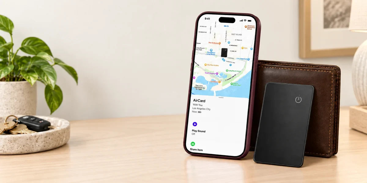 Black tracker card beside a wallet and a phone showing the supplied tracking screen.