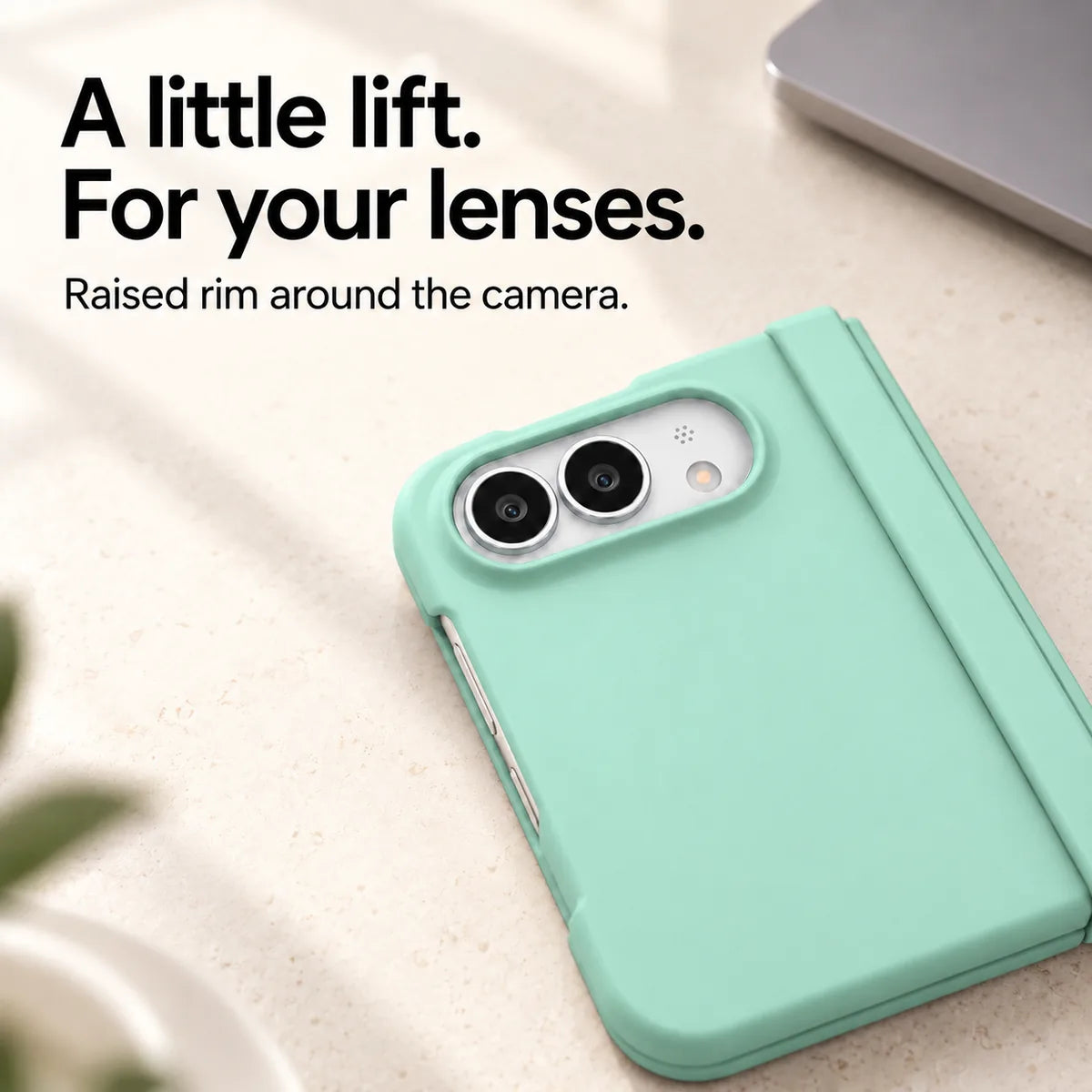 Close-up of the raised Light Green camera rim on a matte iPhone Ultra case resting on a light desk. #color_Seafoam Green