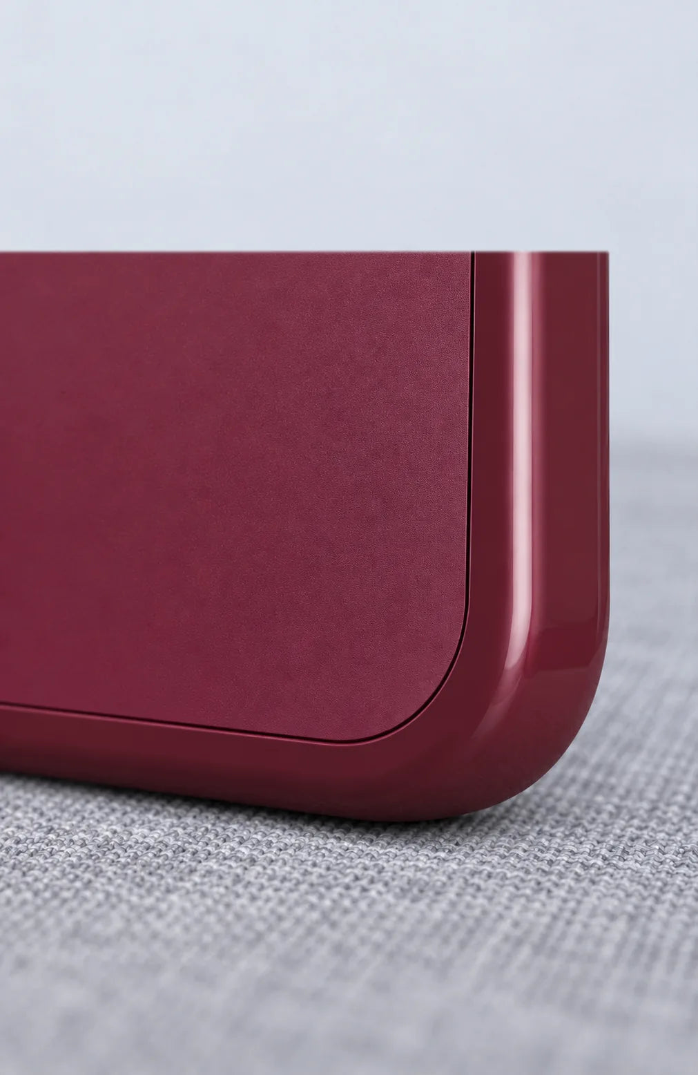 Close-up of the Burgundy phone case corner and matte back panel.
