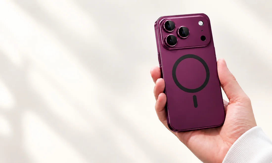 Hand holding a dark cherry metal phone case with a matching phone back and camera surround.
