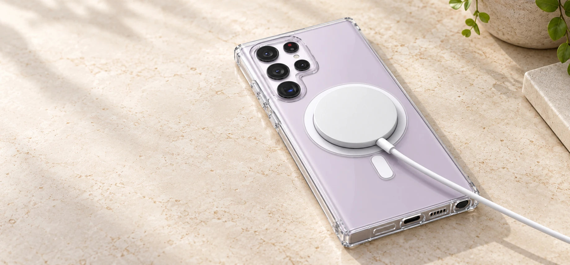 White wireless charging puck attached to a transparent phone case.