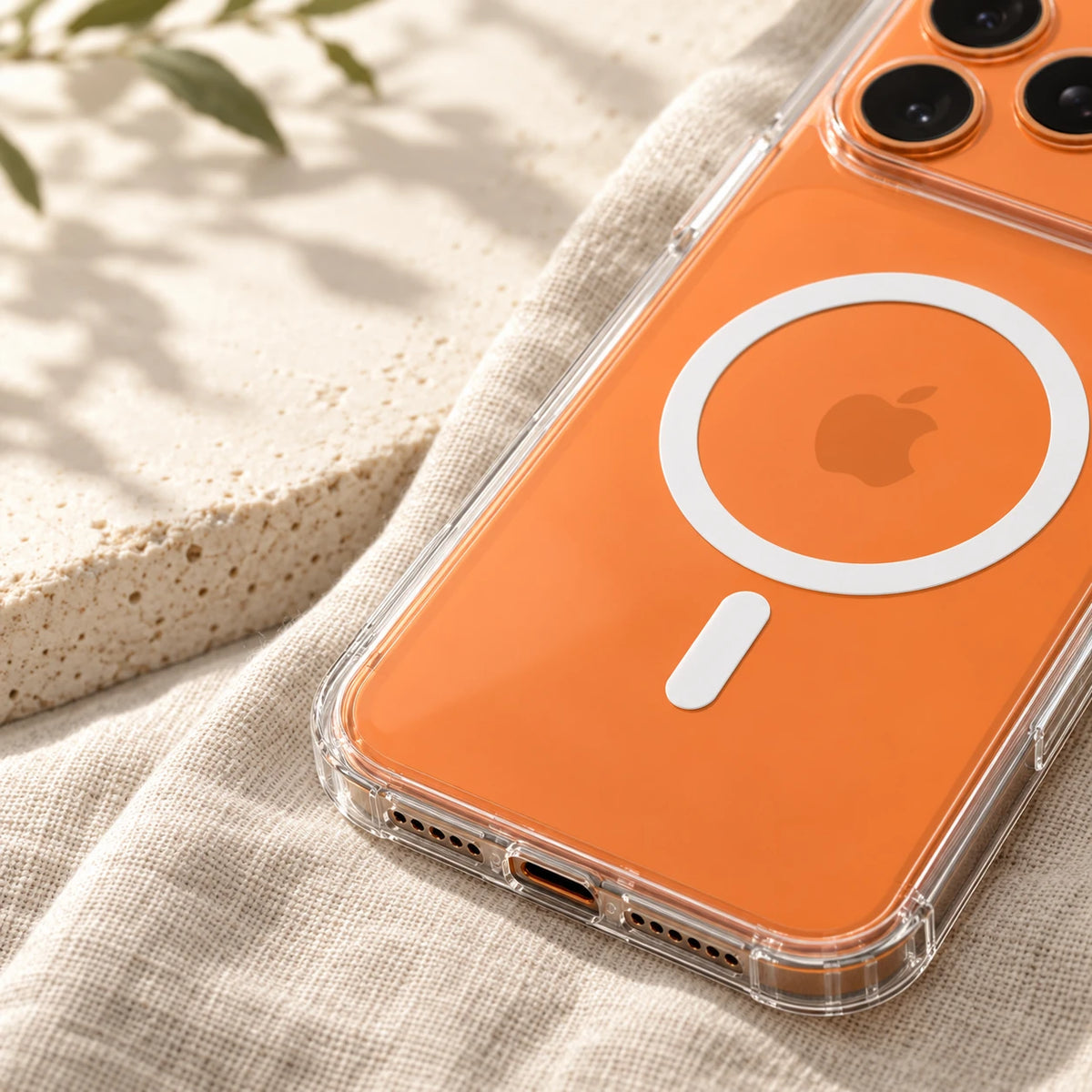 Close-up of a transparent protective phone-case corner with the orange phone visible inside.