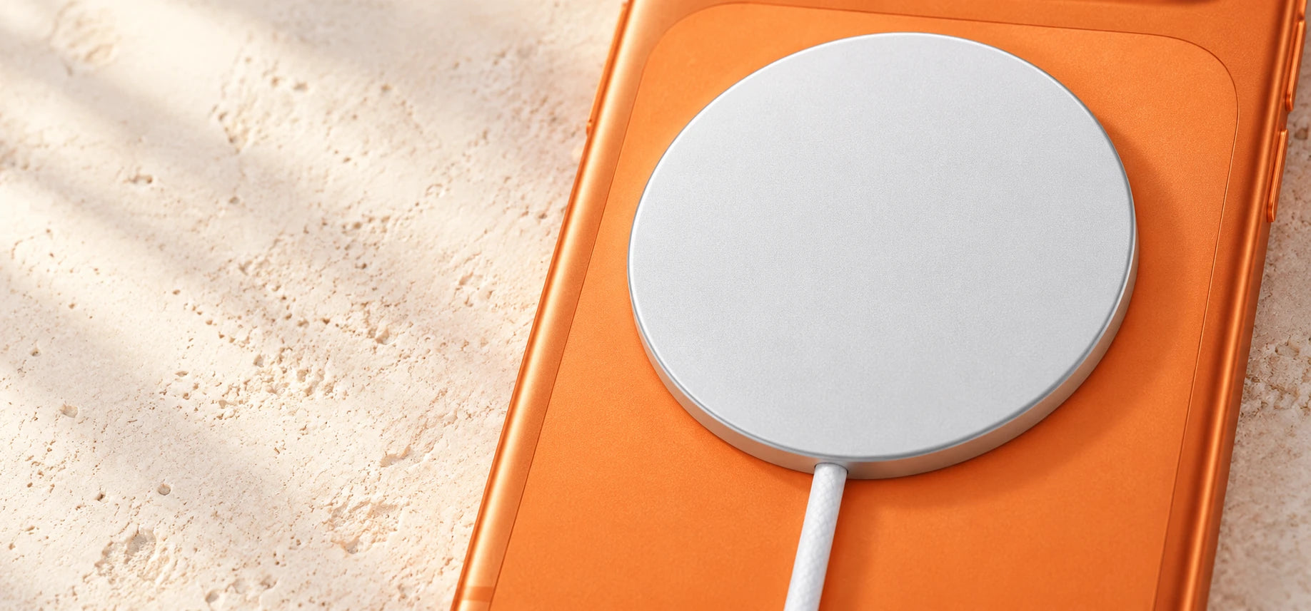 Close-up of a white magnetic charging puck resting flush against a phone back.
